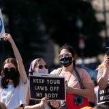 Abortion rights supporters hold up signs as they gather for a pre-march rally of the annual Women's March on Oct. 2 in Washington, D.C. | Joshua Roberts/Getty Images